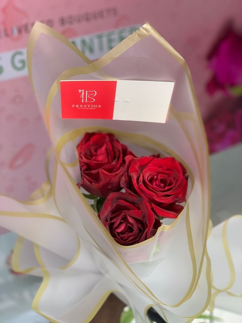 Three perfectly placed red roses, styled with clean elegance. A beautiful and understated way to convey "I'm thinking of you," "I miss you," or "You're special to me.